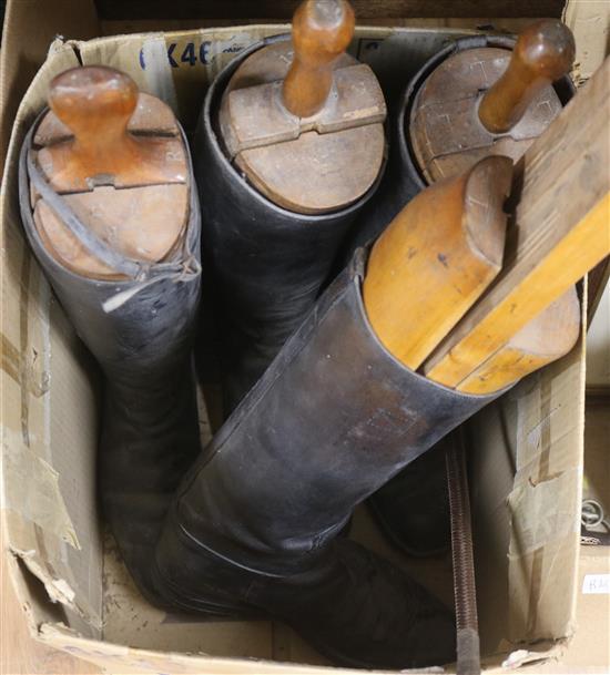 Two pairs of hunting boots with wooden trees and a crop